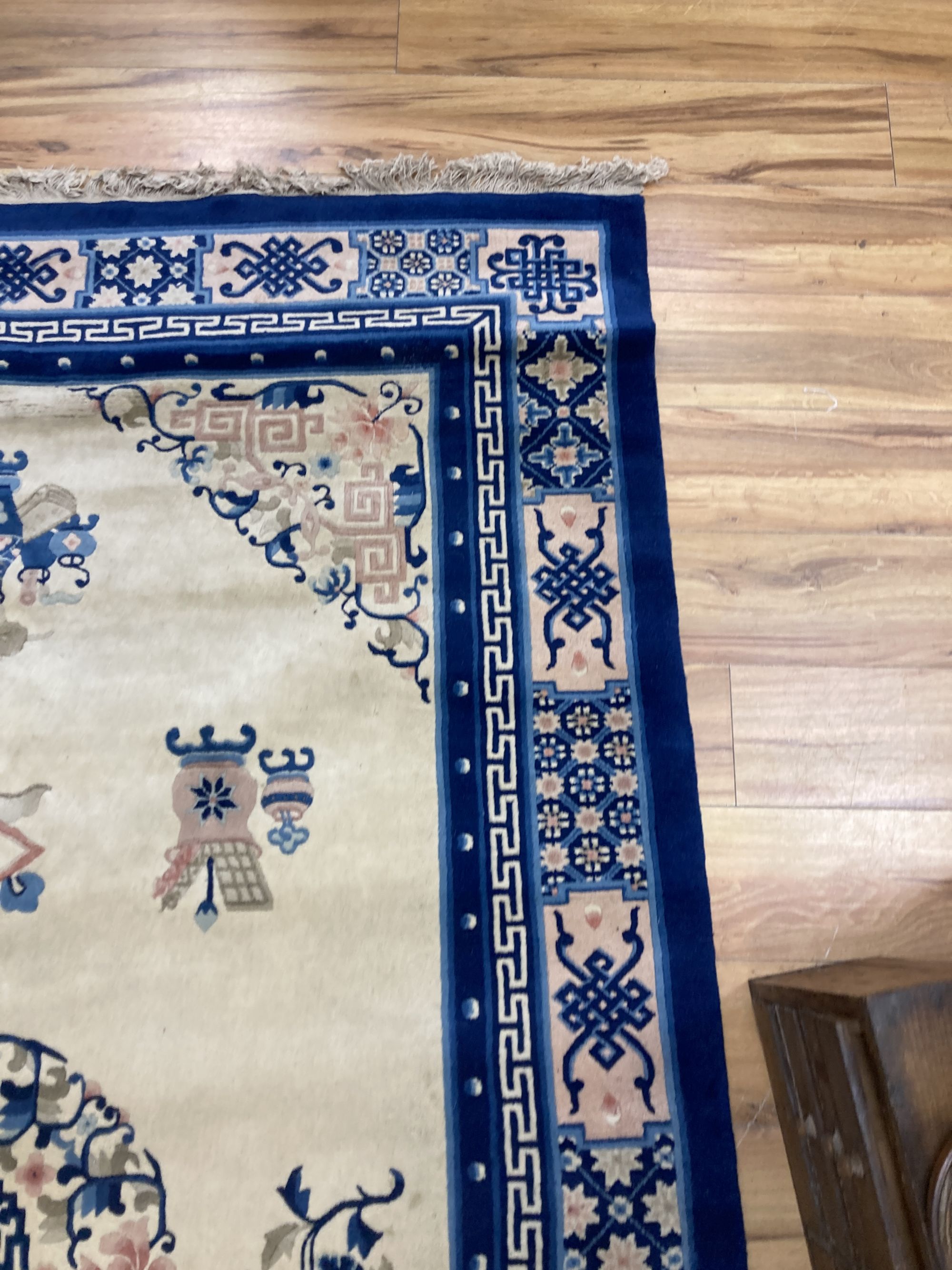 A Chinese wool cream ground rug,